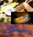 A hand carved logo of the clients company inlaid with natural Azurite.