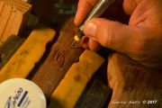 Hand carving the Client's Logo in a Custom Curly Claro Walnut Net by Sierra Nets