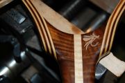 An Inlaid Aluminum fly on a Curly Walnut handle. The hoop is Walnut/Maple